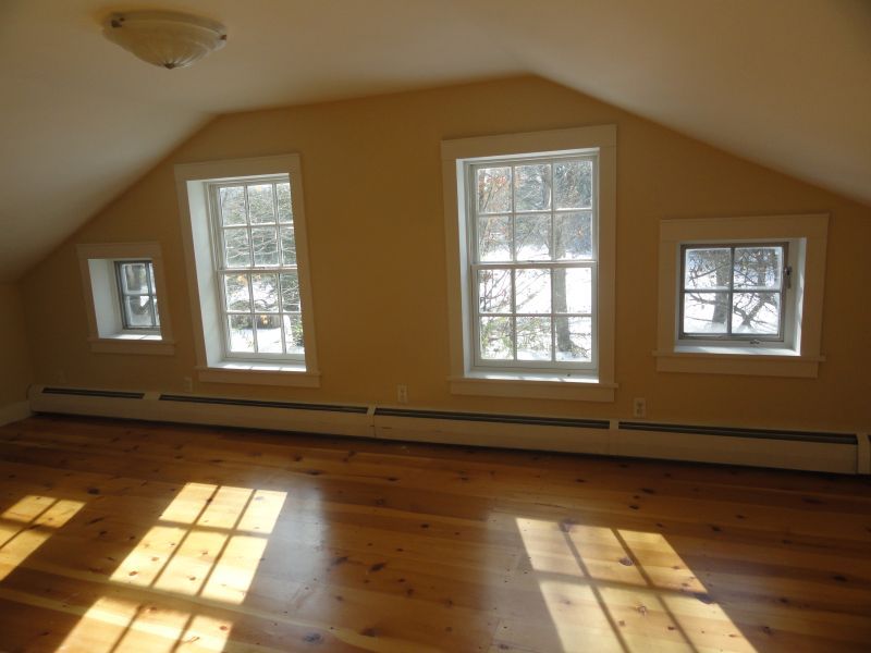 1050 W Road Richmond, MA 01254 - Photo 5 of 11 a view of empty room with wooden floor and fan