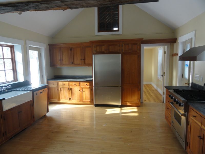 1050 W Road Richmond, MA 01254 - Photo 10 of 11 a kitchen with stainless steel appliances granite countertop a stove a refrigerator and a cabinets