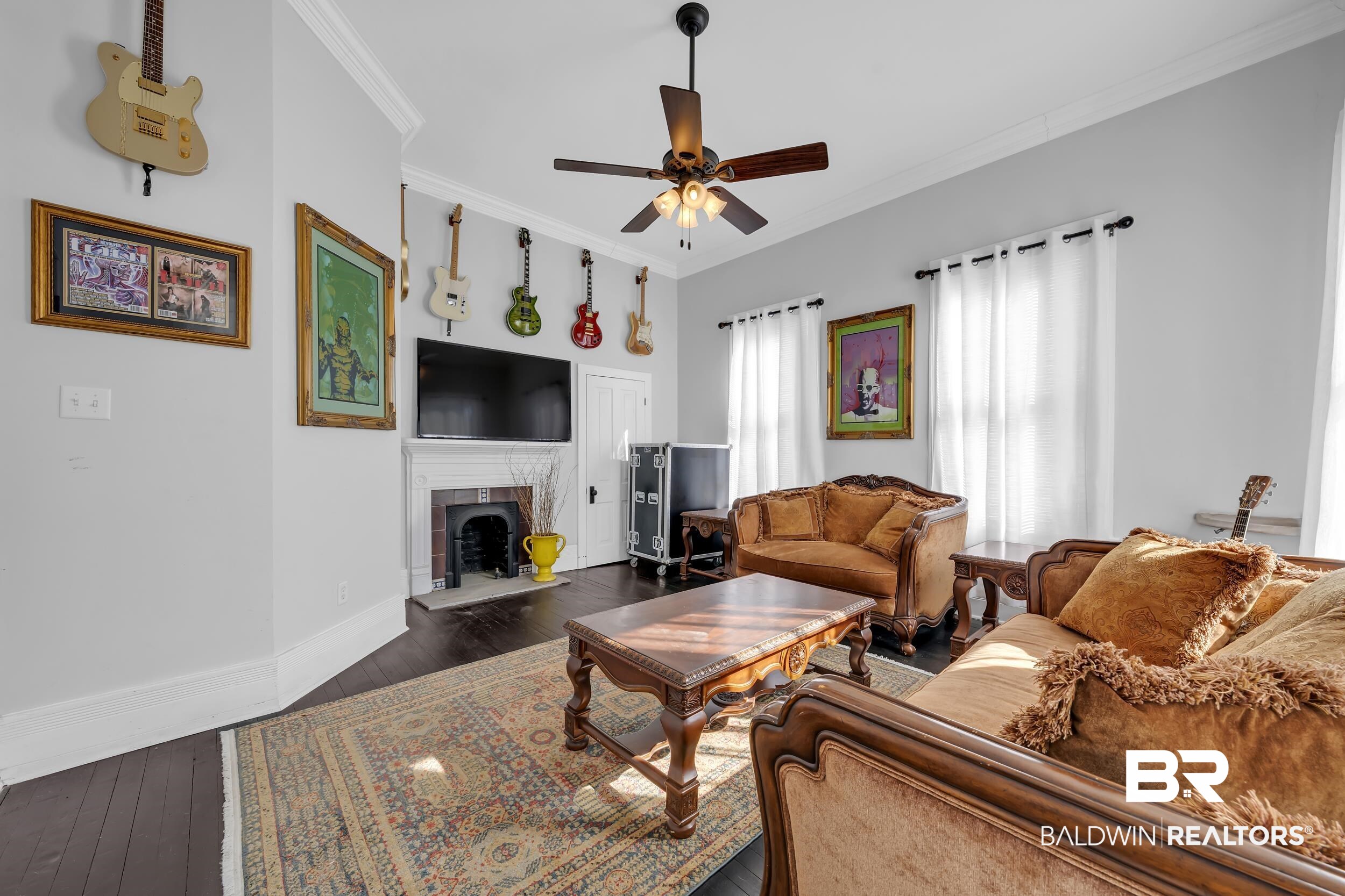 1322 Dauphin Street Mobile, AL 36604 - Photo 8 of 21 Living area with dark wood-style flooring, ornamental molding, a tiled fireplace, and a ceiling fan