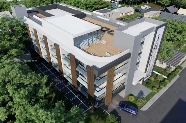 an aerial view of multiple houses with a yard