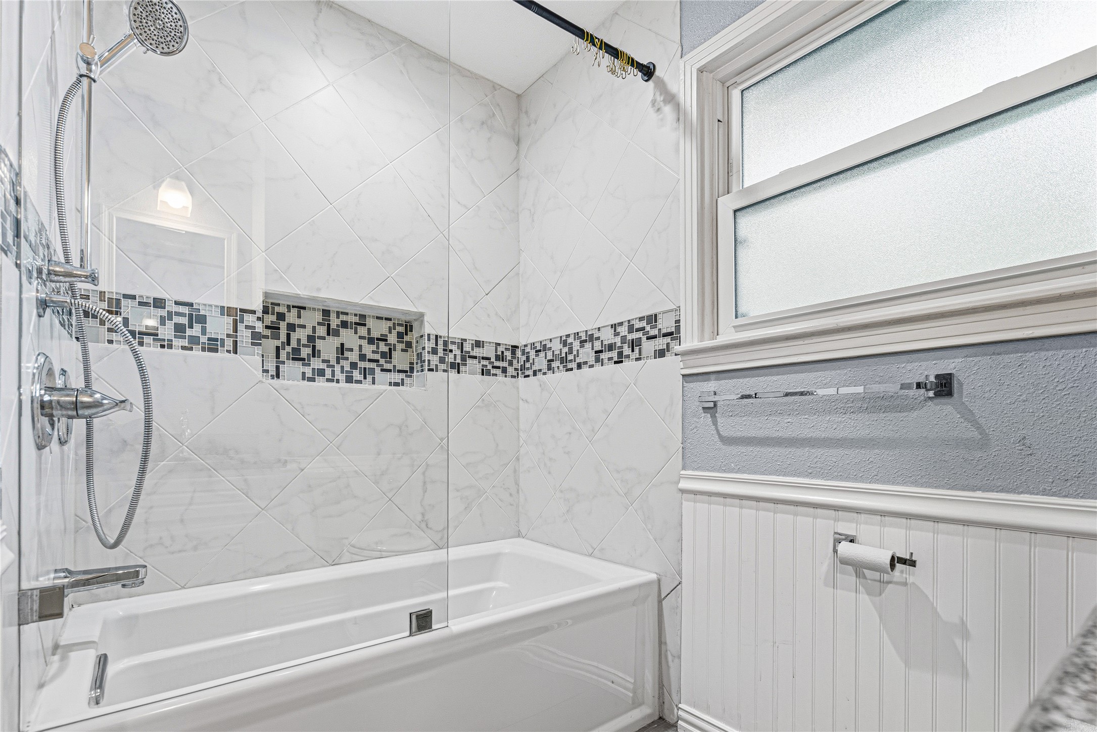 4002 Merrick Street Houston, TX 77025 - Photo 9 of 22 a bathroom with a shower and a bathtub