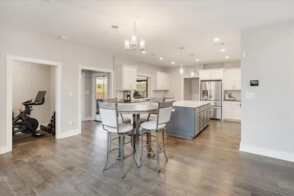 a living room with furniture and kitchen view