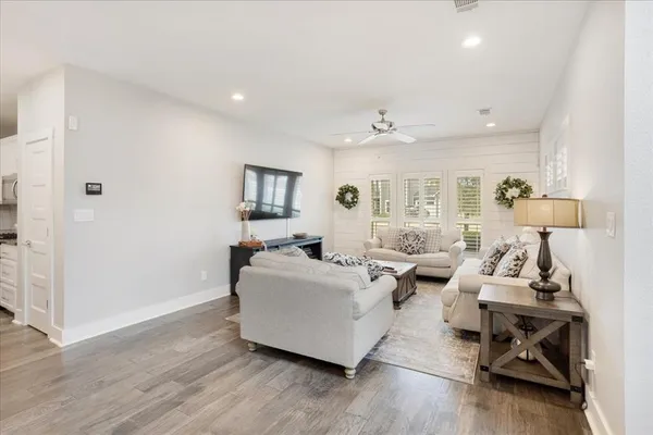 a living room with furniture and a wooden floor