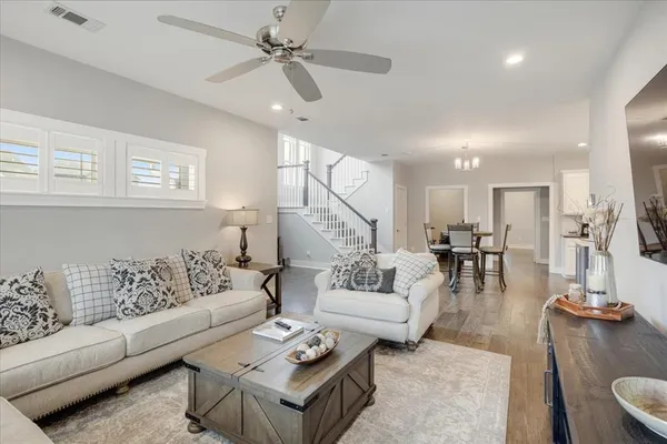 a living room with furniture and wooden floor
