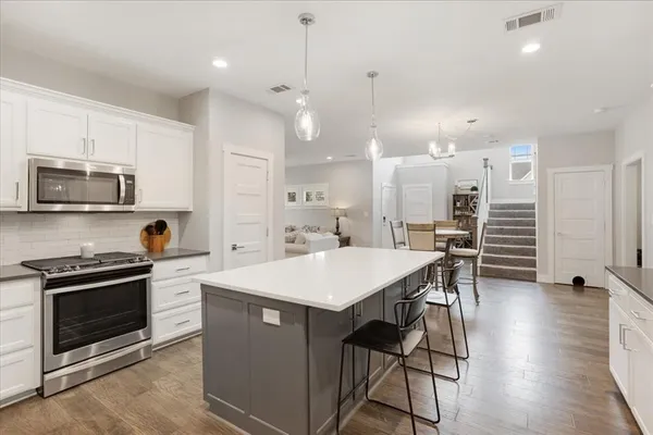 a large kitchen with a table and chairs