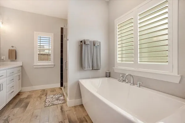 a white bath tub sitting next to a window