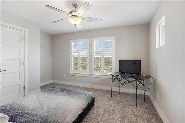 a bedroom with a bed a chair and a chandelier