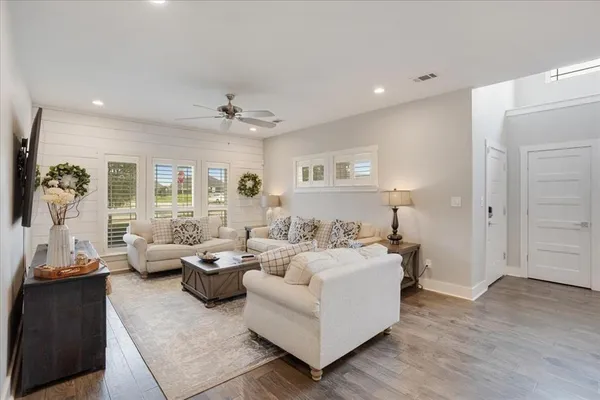 a living room with furniture and wooden floor