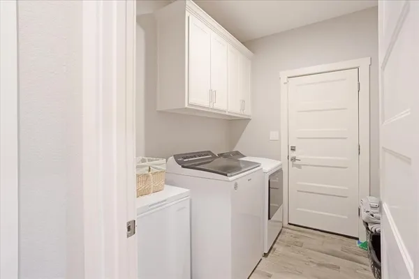 a utility room with sink dryer and washer