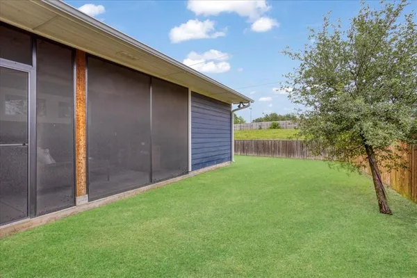 a backyard of a house with lots of green space