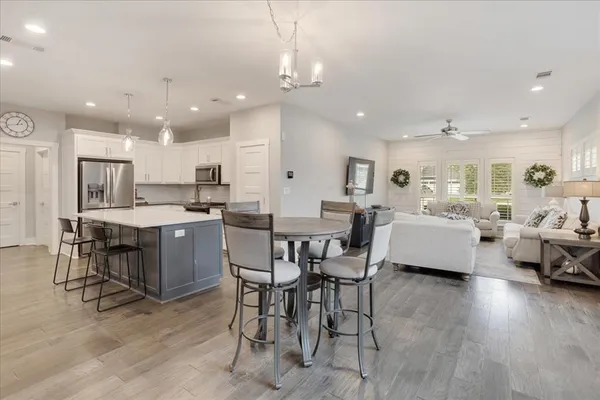 a large kitchen with a table and chairs
