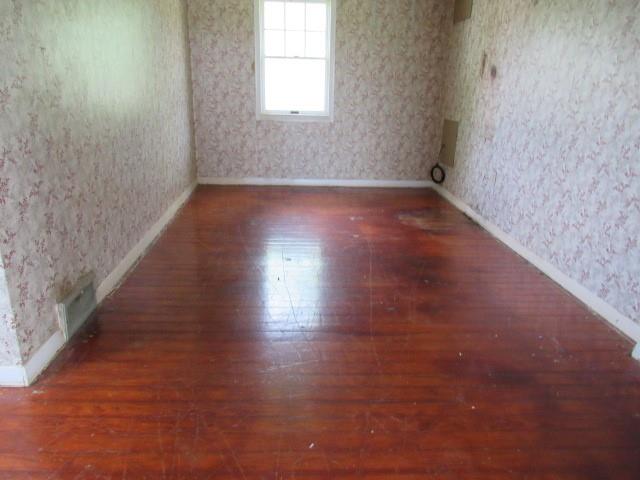 1052 North Eighty Eight Road Rices Landing, PA 15357 - Photo 14 of 24 an empty room with wooden floor and windows