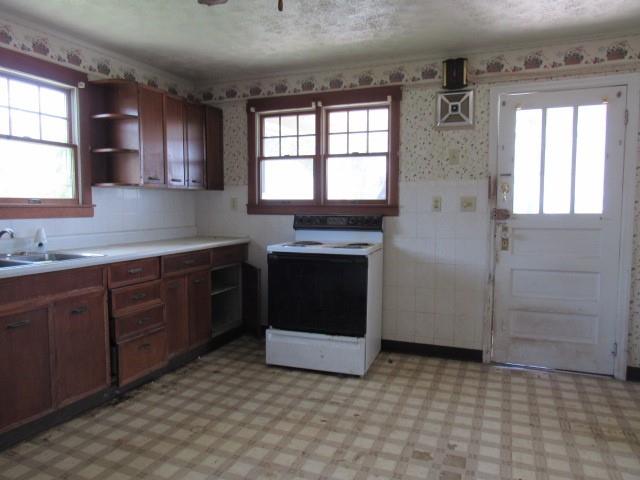 1052 North Eighty Eight Road Rices Landing, PA 15357 - Photo 8 of 24 a kitchen with stainless steel appliances granite countertop a stove a sink and a refrigerator