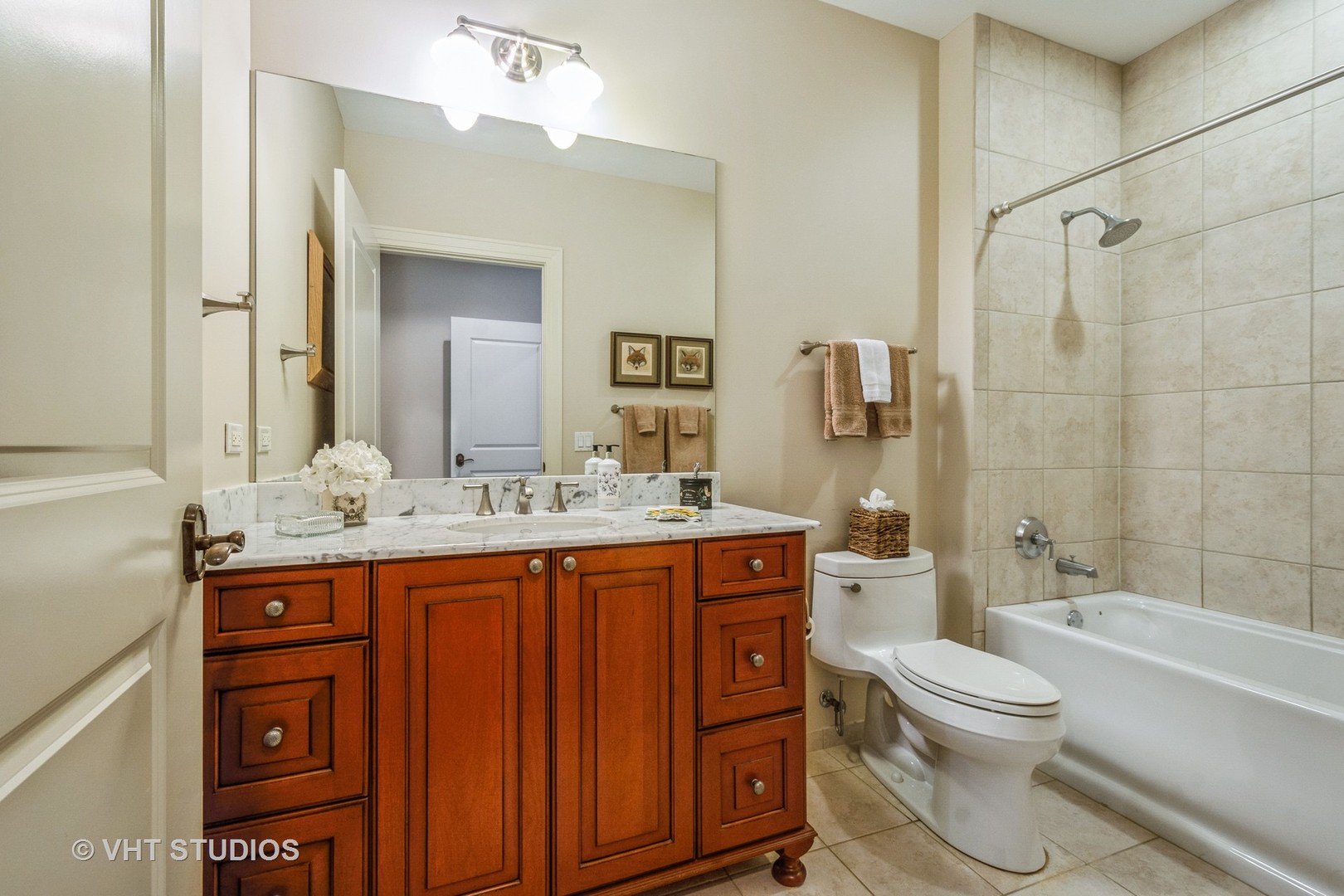 1041 Ridge Road, Unit 101 Wilmette, IL 60091 - Photo 12 of 14 a bathroom with a granite countertop toilet a sink and a bathtub