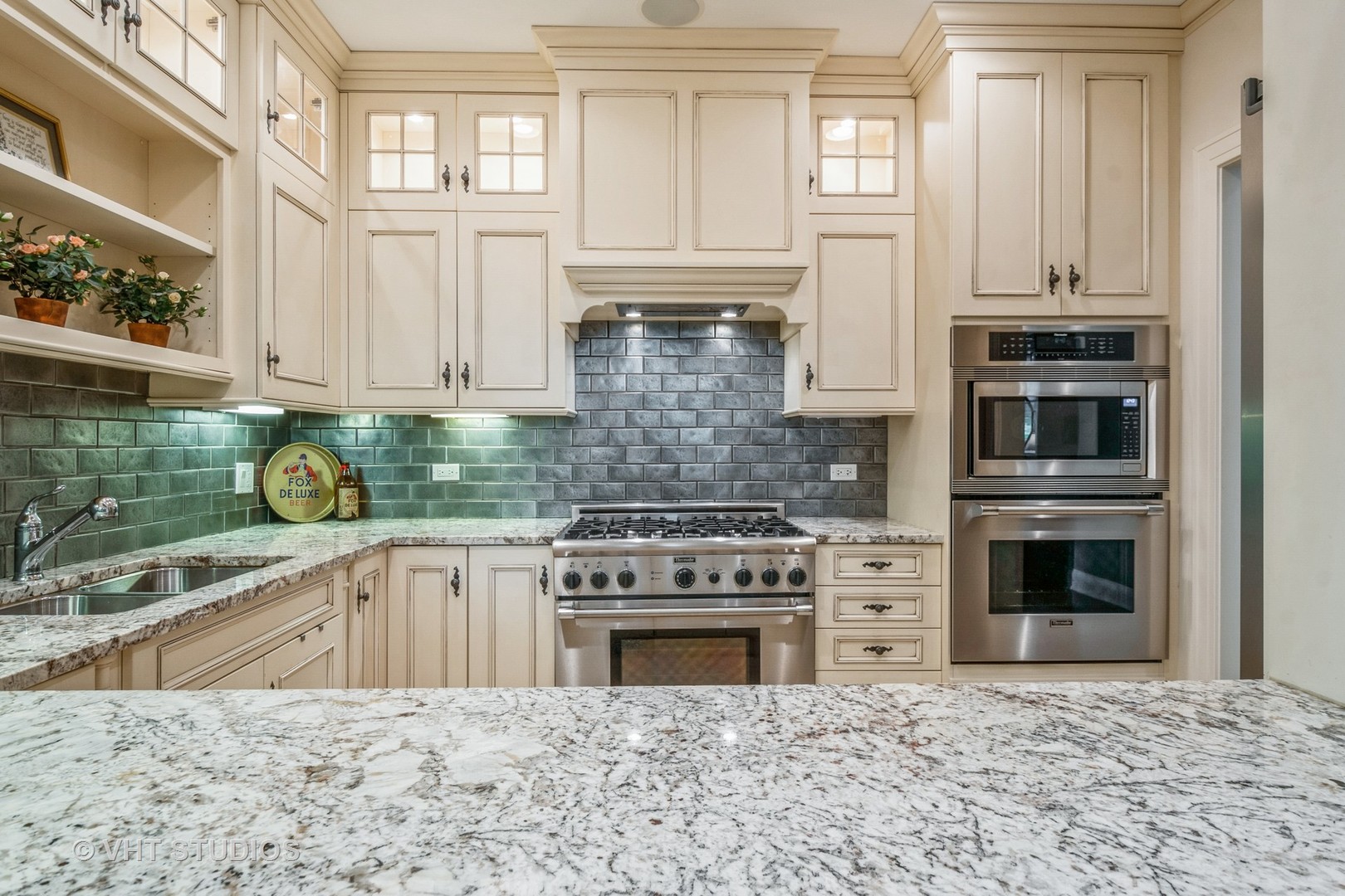 1041 Ridge Road, Unit 101 Wilmette, IL 60091 - Photo 8 of 14 a kitchen with stainless steel appliances granite countertop a stove sink and cabinets