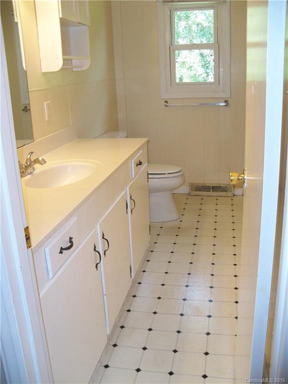 126 Pea Ridge Road Mill Spring, NC 28756 - Photo 13 of 24 a bathroom with a sink a toilet and a shower