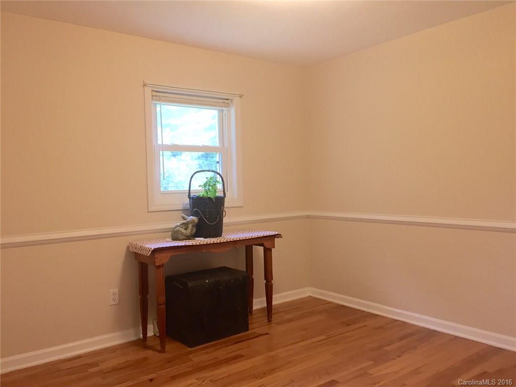 126 Pea Ridge Road Mill Spring, NC 28756 - Photo 15 of 24 a view of a small space with wooden floor and a window