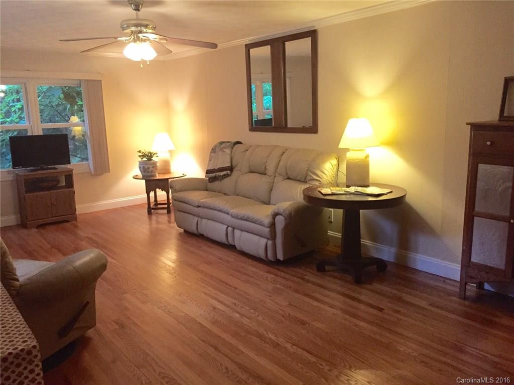 126 Pea Ridge Road Mill Spring, NC 28756 - Photo 3 of 24 a living room with furniture and a wooden floor