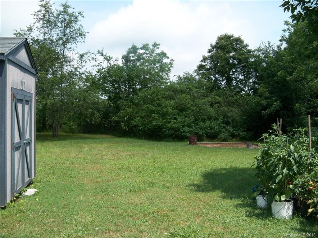 126 Pea Ridge Road Mill Spring, NC 28756 - Photo 23 of 24 a backyard of a house with lots of green space