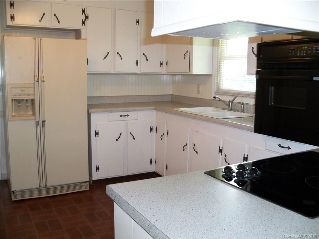 126 Pea Ridge Road Mill Spring, NC 28756 - Photo 7 of 24 a kitchen with cabinets and appliances