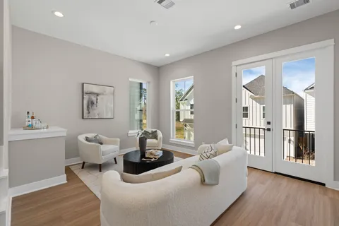 a living room with furniture and wooden floor
