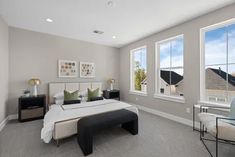 a bedroom with a large bed and a window