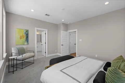 a bedroom with a bed and couch