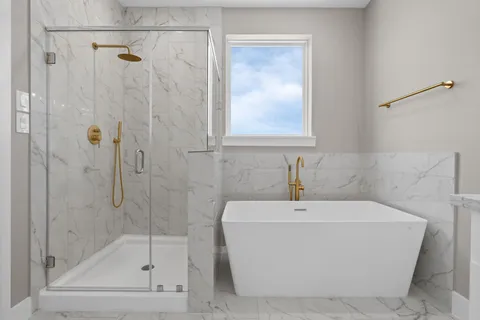 a white bath tub sitting next to a shower