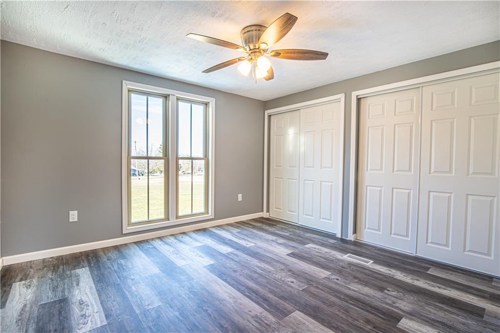 69 Marker Road Farmington, PA 15437 - Photo 8 of 16 an empty room with wooden floor and windows