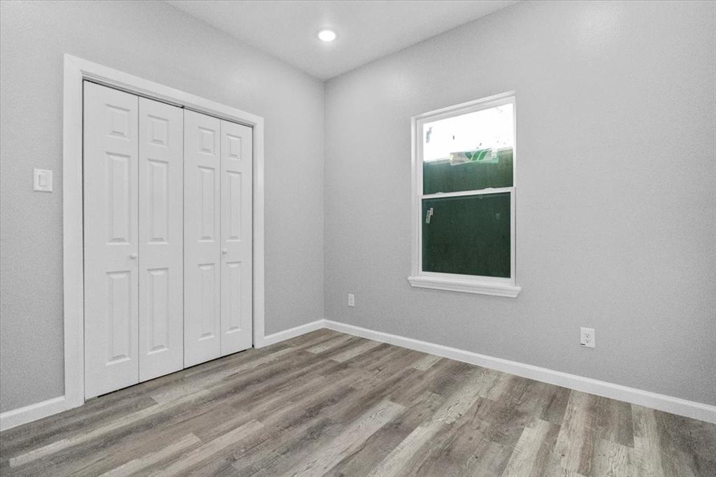 3512 Hamilton Avenue Dallas, TX 75210 - Photo 11 of 23 Unfurnished bedroom with light wood-style floors and a closet