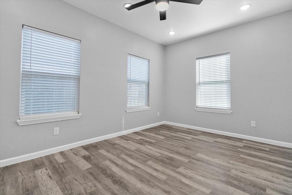 3512 Hamilton Avenue Dallas, TX 75210 - Photo 13 of 23 Empty room featuring light wood-style floors, healthy amount of natural light, ceiling fan, and recessed lighting