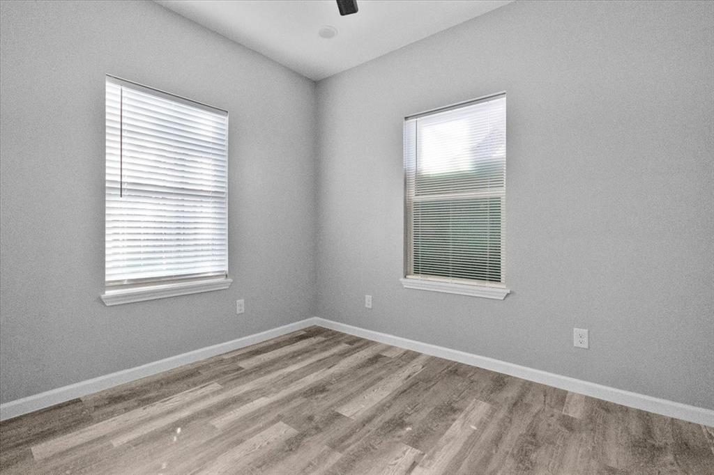 3512 Hamilton Avenue Dallas, TX 75210 - Photo 20 of 23 Empty room featuring light wood-style flooring and ceiling fan