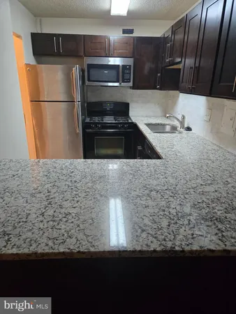 a kitchen with kitchen island a counter top space and cabinets