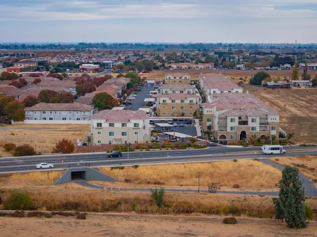 an aerial view of residential houses with outdoor space