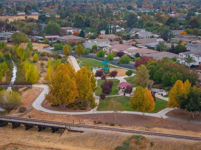 an aerial view of a house with a yard and lake view