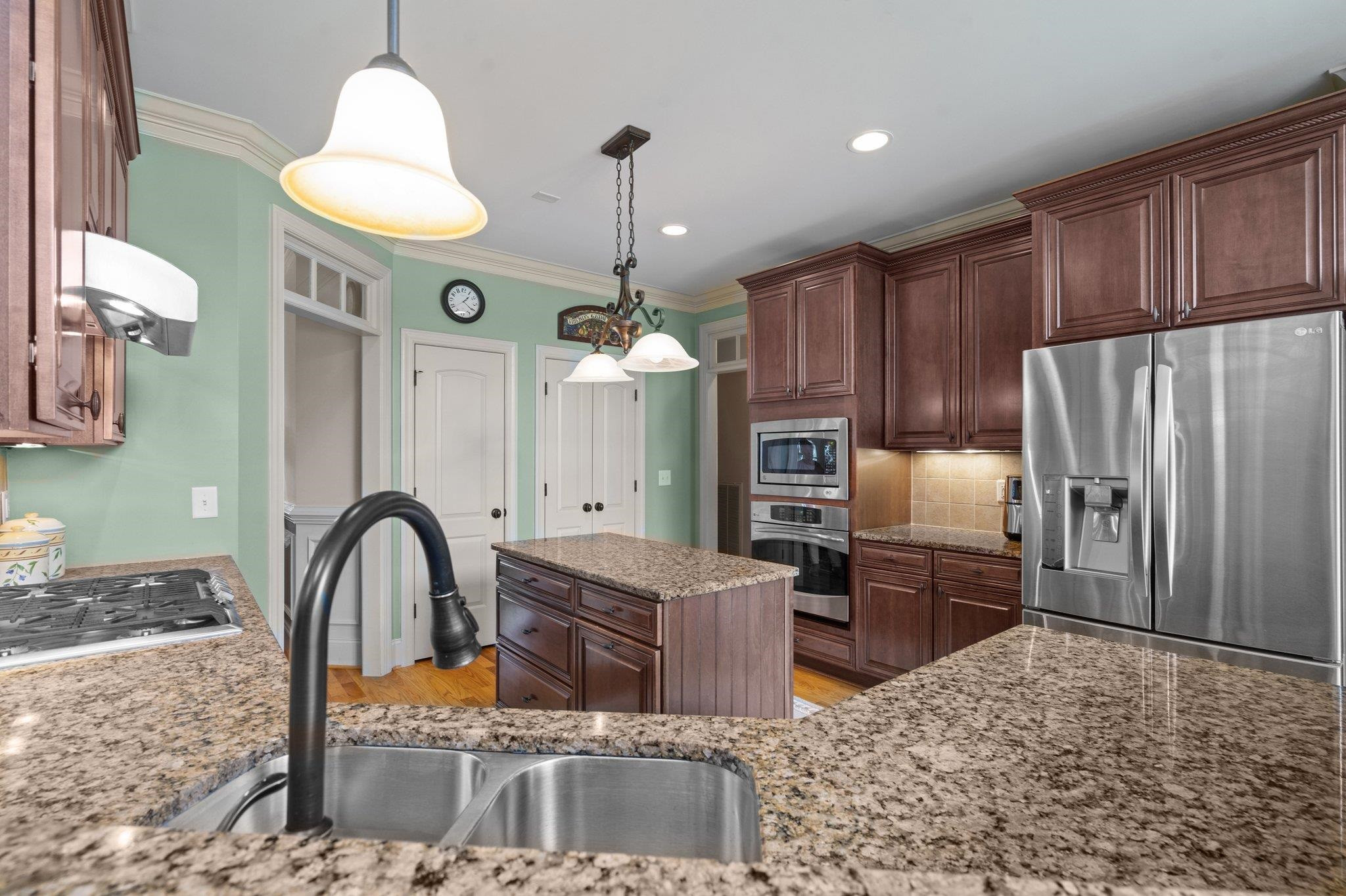 5805 Clovis Ridge Drive Wake Forest, NC 27587 - Photo 11 of 64 a kitchen with stainless steel appliances granite countertop a refrigerator a stove a sink and a dining table