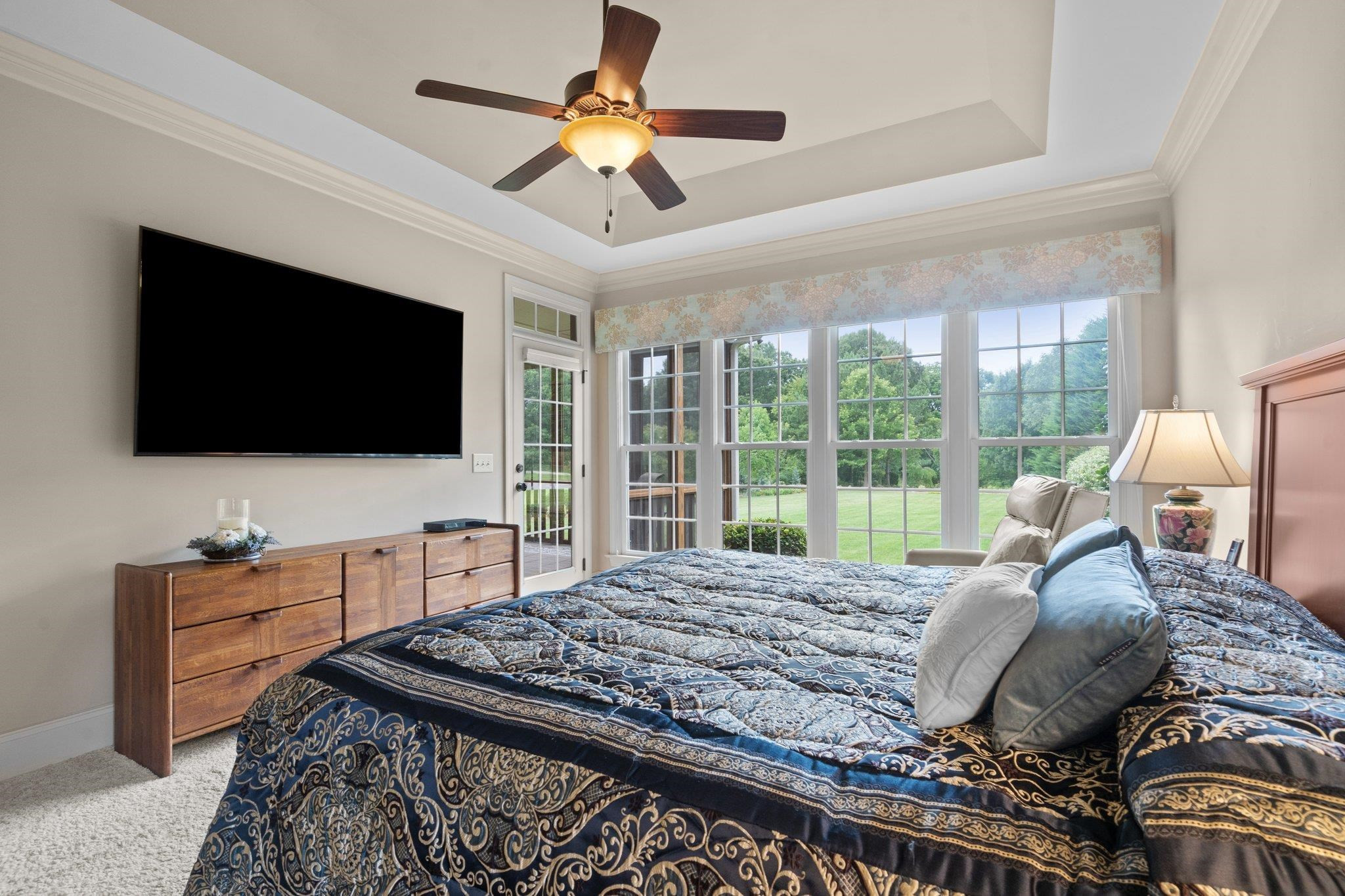 5805 Clovis Ridge Drive Wake Forest, NC 27587 - Photo 21 of 64 a bed room with a bed television and a large window