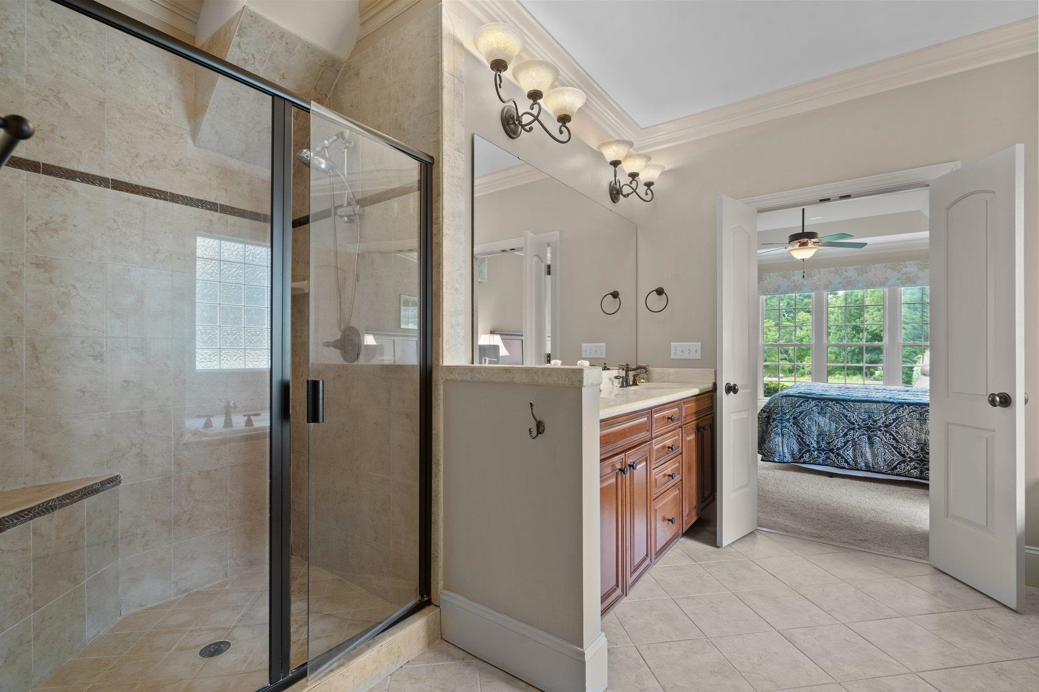 5805 Clovis Ridge Drive Wake Forest, NC 27587 - Photo 24 of 64 a bathroom with a granite countertop shower a sink and a mirror