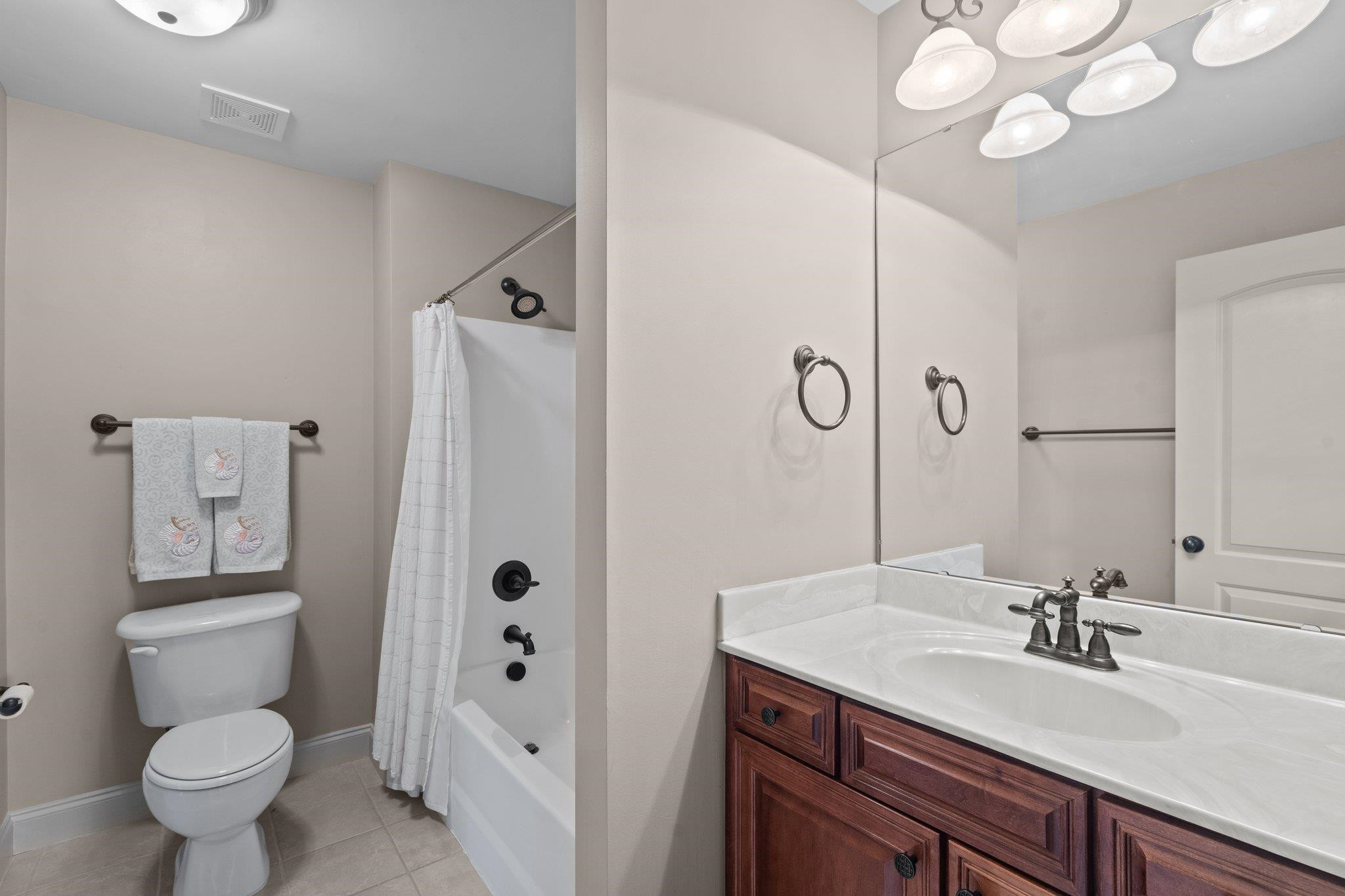 5805 Clovis Ridge Drive Wake Forest, NC 27587 - Photo 37 of 64 a bathroom with a sink a toilet a mirror a vanity and shower