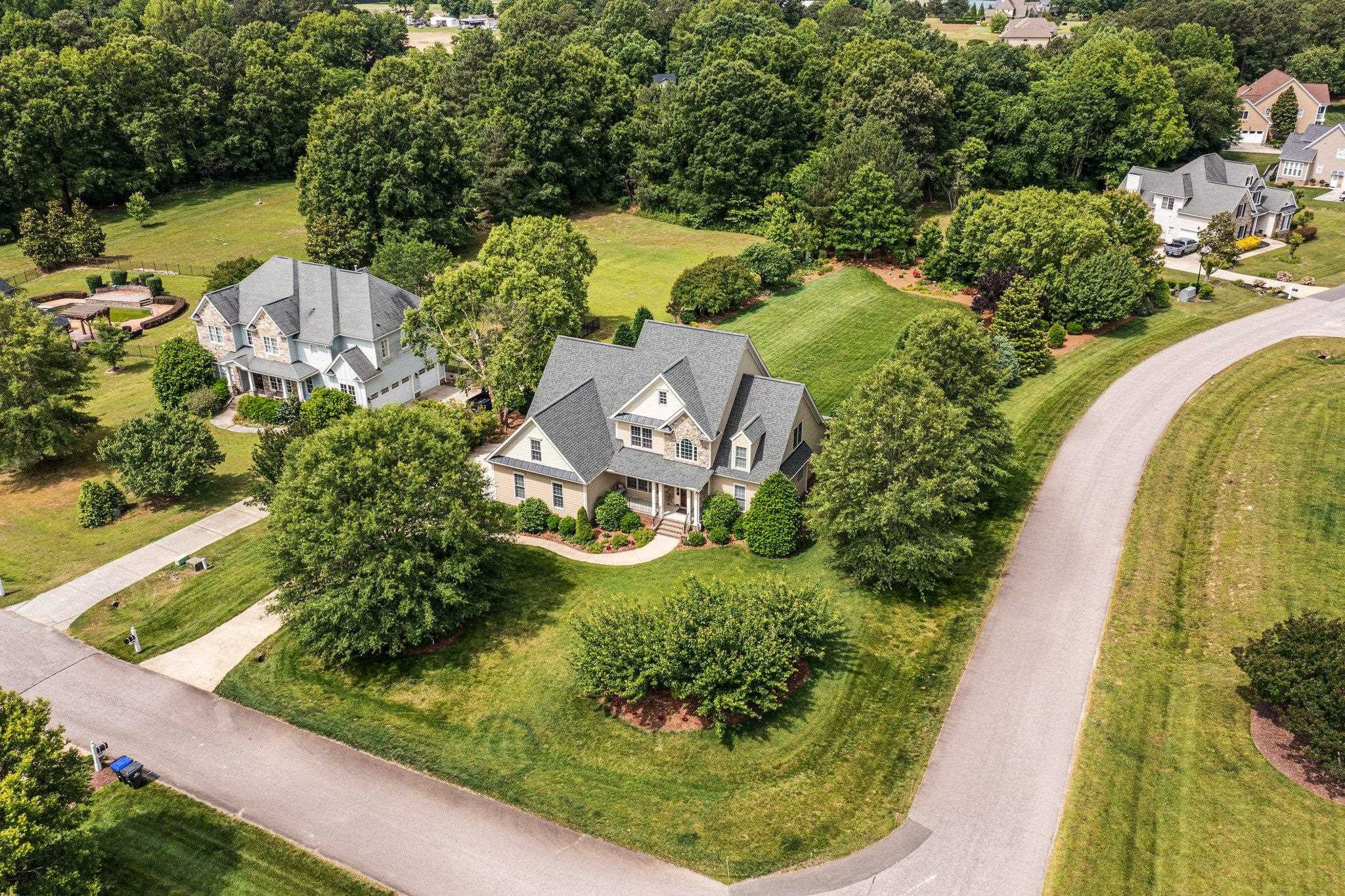 5805 Clovis Ridge Drive Wake Forest, NC 27587 - Photo 56 of 64 an aerial view of a house with a yard lake and outdoor seating