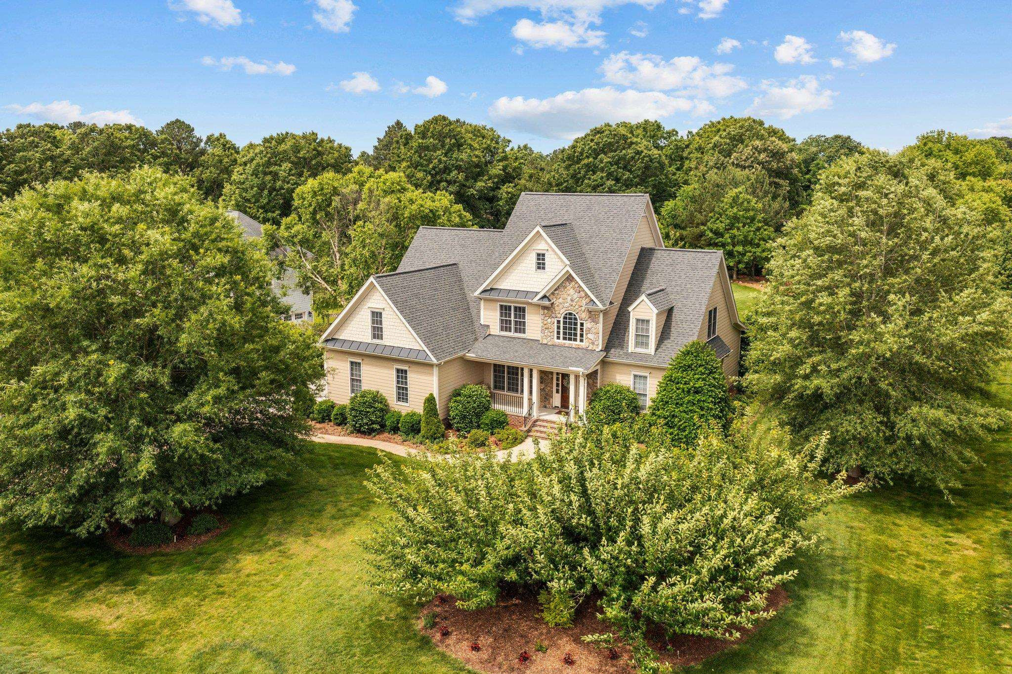 5805 Clovis Ridge Drive Wake Forest, NC 27587 - Photo 58 of 64 a aerial view of a house with swimming pool and large trees