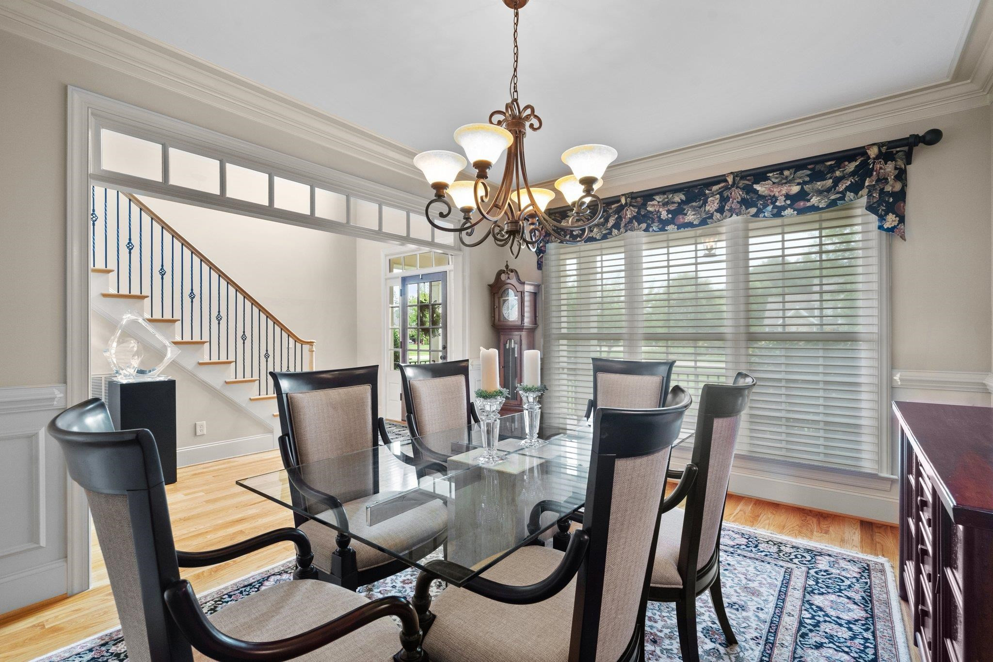5805 Clovis Ridge Drive Wake Forest, NC 27587 - Photo 7 of 64 a view of a dining room with furniture and a chandelier