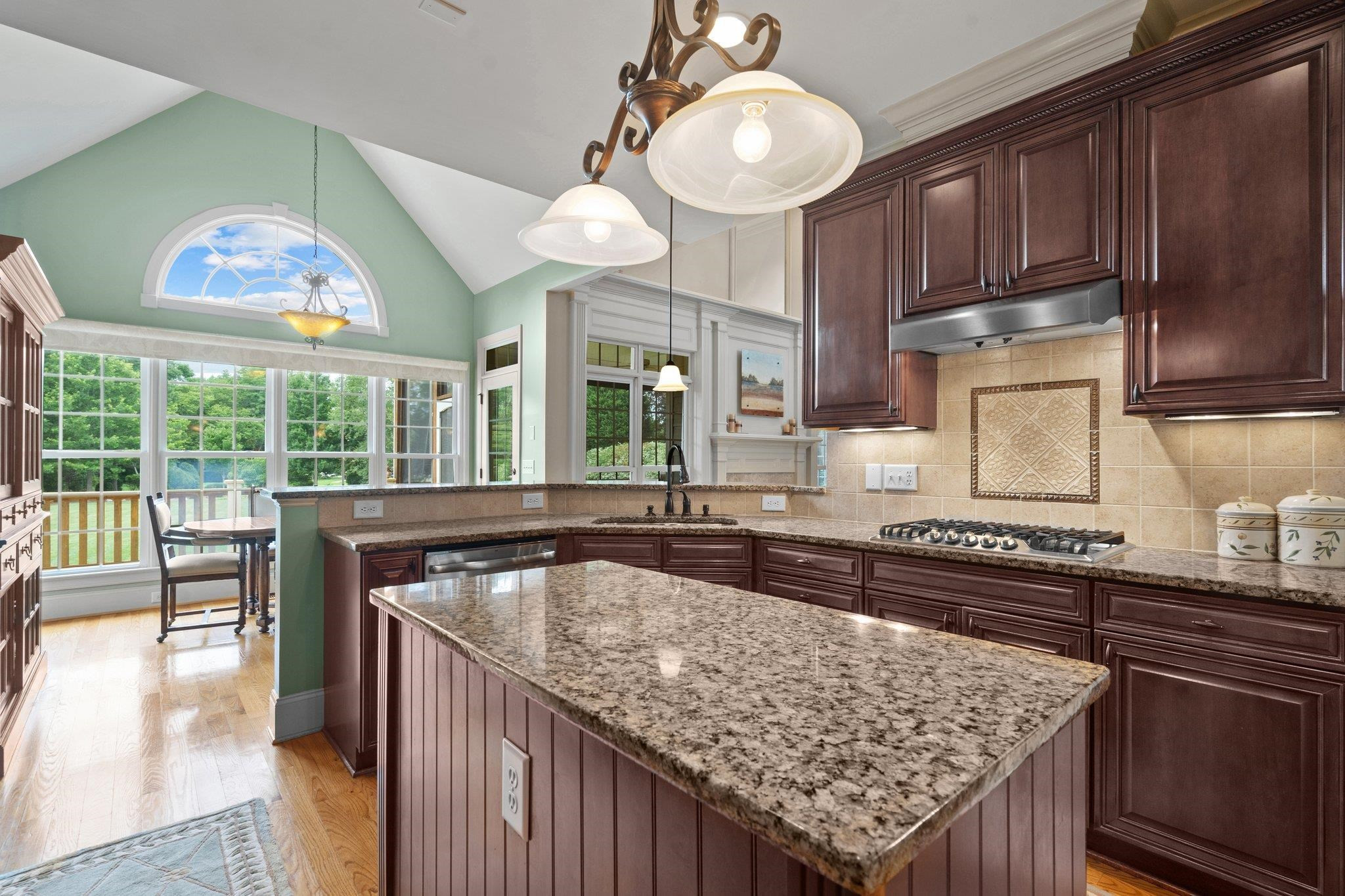 5805 Clovis Ridge Drive Wake Forest, NC 27587 - Photo 9 of 64 a kitchen with stainless steel appliances granite countertop a stove a sink and a microwave