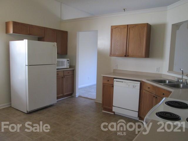 1941 Decatur Court Charlotte, NC 28213 - Photo 4 of 9 a kitchen with a refrigerator and a sink