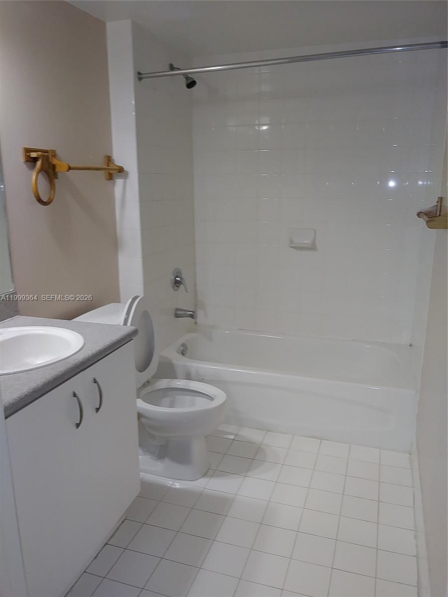 816 Northwest 11th Street, Unit 1002 Miami, FL 33136 - Photo 11 of 19 a bathroom with a sink a toilet and shower
