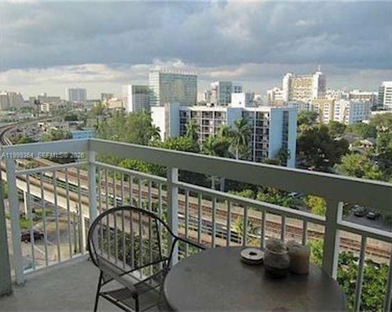 816 Northwest 11th Street, Unit 1002 Miami, FL 33136 - Photo 17 of 19 a view of a balcony with two chairs and a table