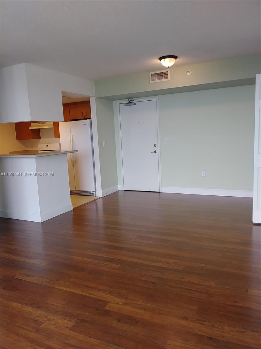 816 Northwest 11th Street, Unit 1002 Miami, FL 33136 - Photo 2 of 19 a view of a room with wooden floor and cabinet