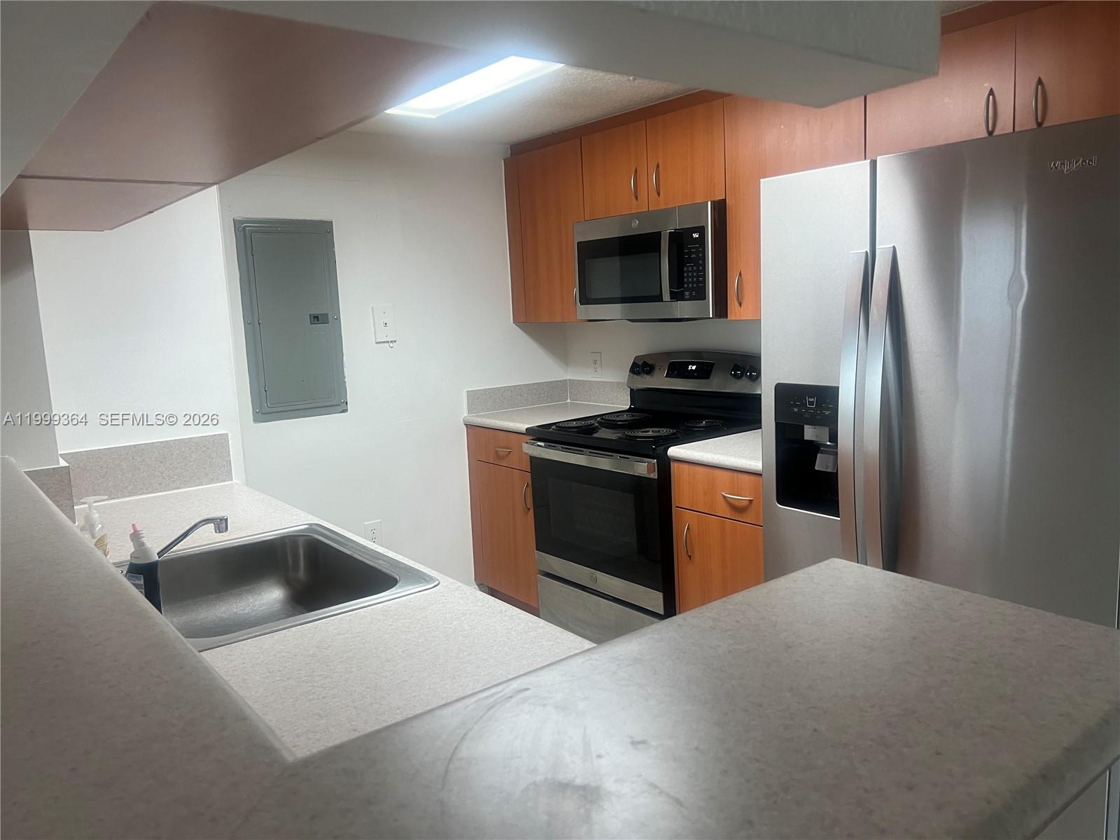 816 Northwest 11th Street, Unit 1002 Miami, FL 33136 - Photo 3 of 19 a kitchen with stainless steel appliances a refrigerator stove and microwave