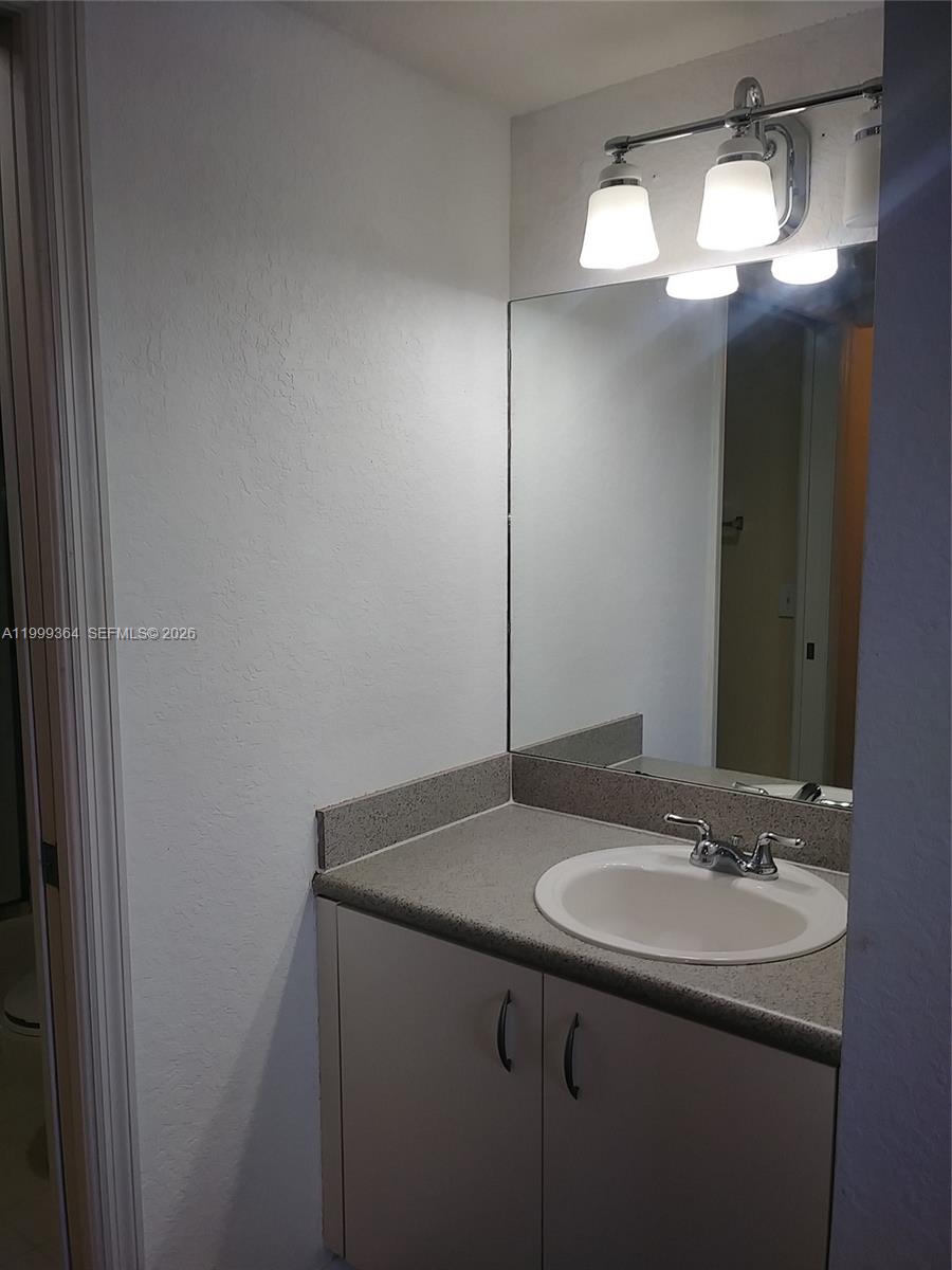 816 Northwest 11th Street, Unit 1002 Miami, FL 33136 - Photo 7 of 19 a bathroom with a sink and a mirror