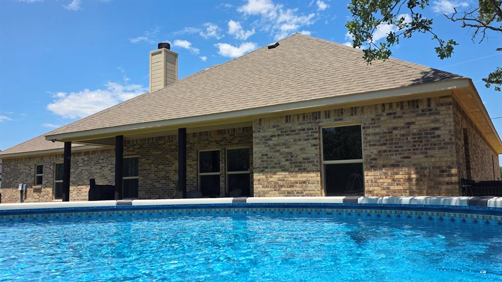 223 Cottongame Road Weatherford, TX 76088 - Photo 31 of 39 a backyard of a house with table and chairs